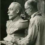 Photograph of Herbert Tyson-Smith working closely on a sculpture of a bust, possibly George V ©National Trust Images/Edward Chambré Hardman Collection