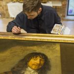 National Trust conservator Mark Searle touching up an 18th-century frame with watercolours in the new conservation studio at Knole, Kent © National Trust Images/James Dobson