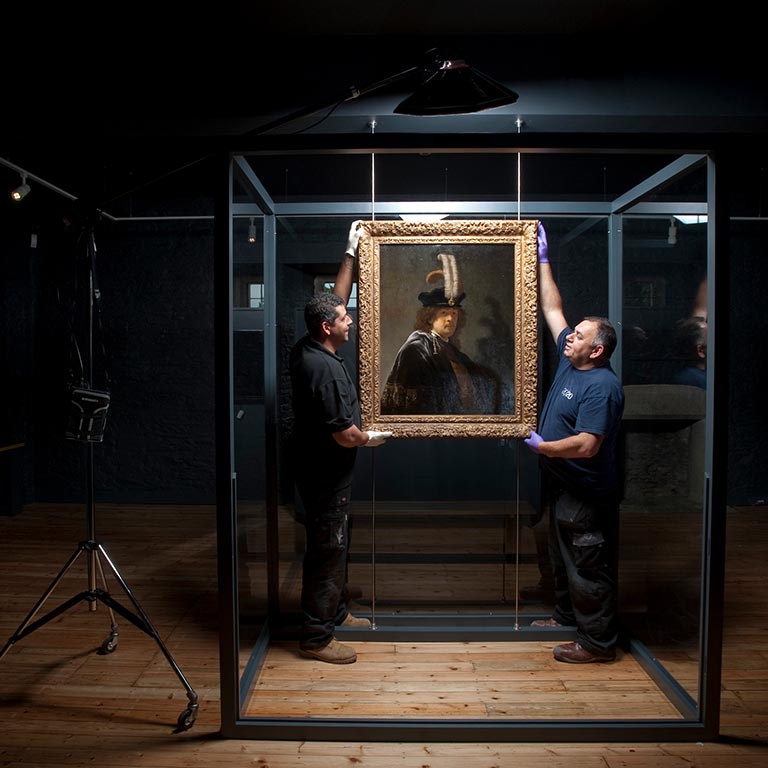Rembrandt self-portrait, being installed for The National Trust’s 2014 exhibition at Buckland Abbey. Image from: https://bit.ly/2uAc6Za